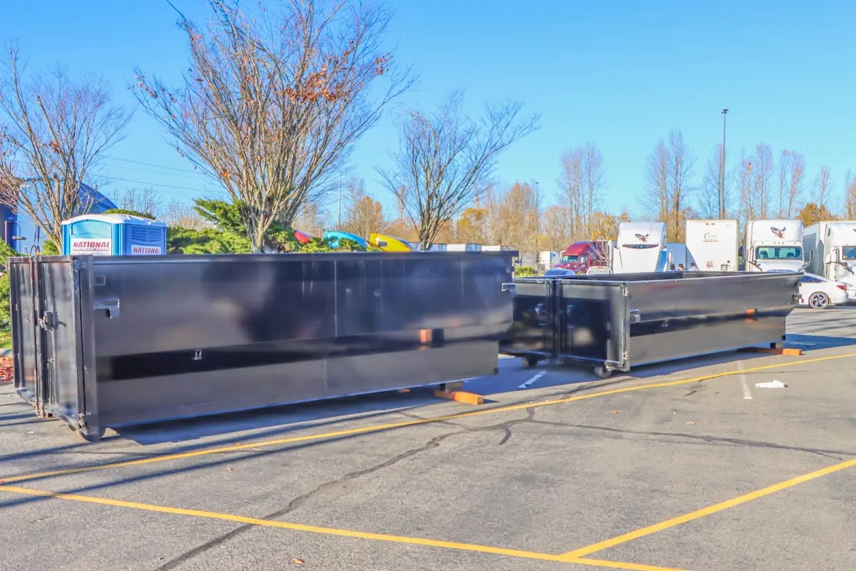 Professional dumpster rental service with roll-off container on residential driveway in Seneca